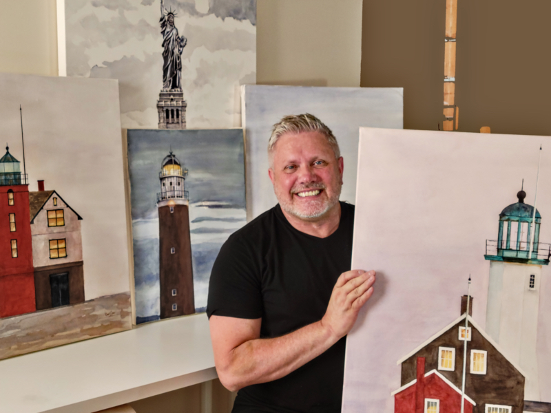 Brad Jones with his lighthouse painting collection