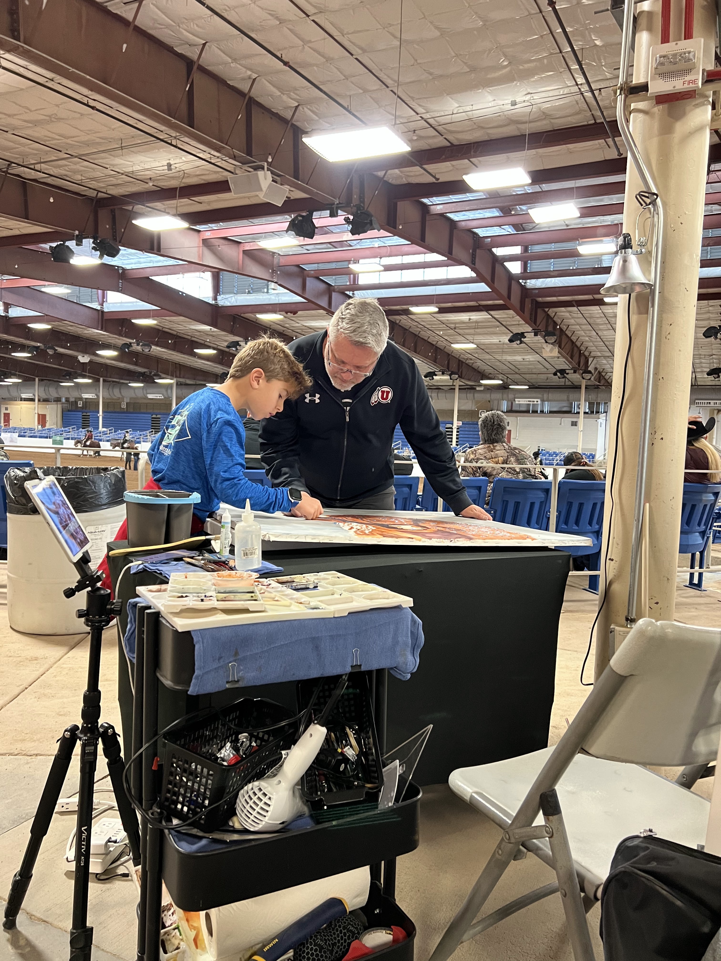 Brad Jones sharing art with a young visitor